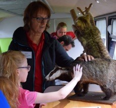 Wild about Scotland volunteer Joyce with visitors aboard the bus