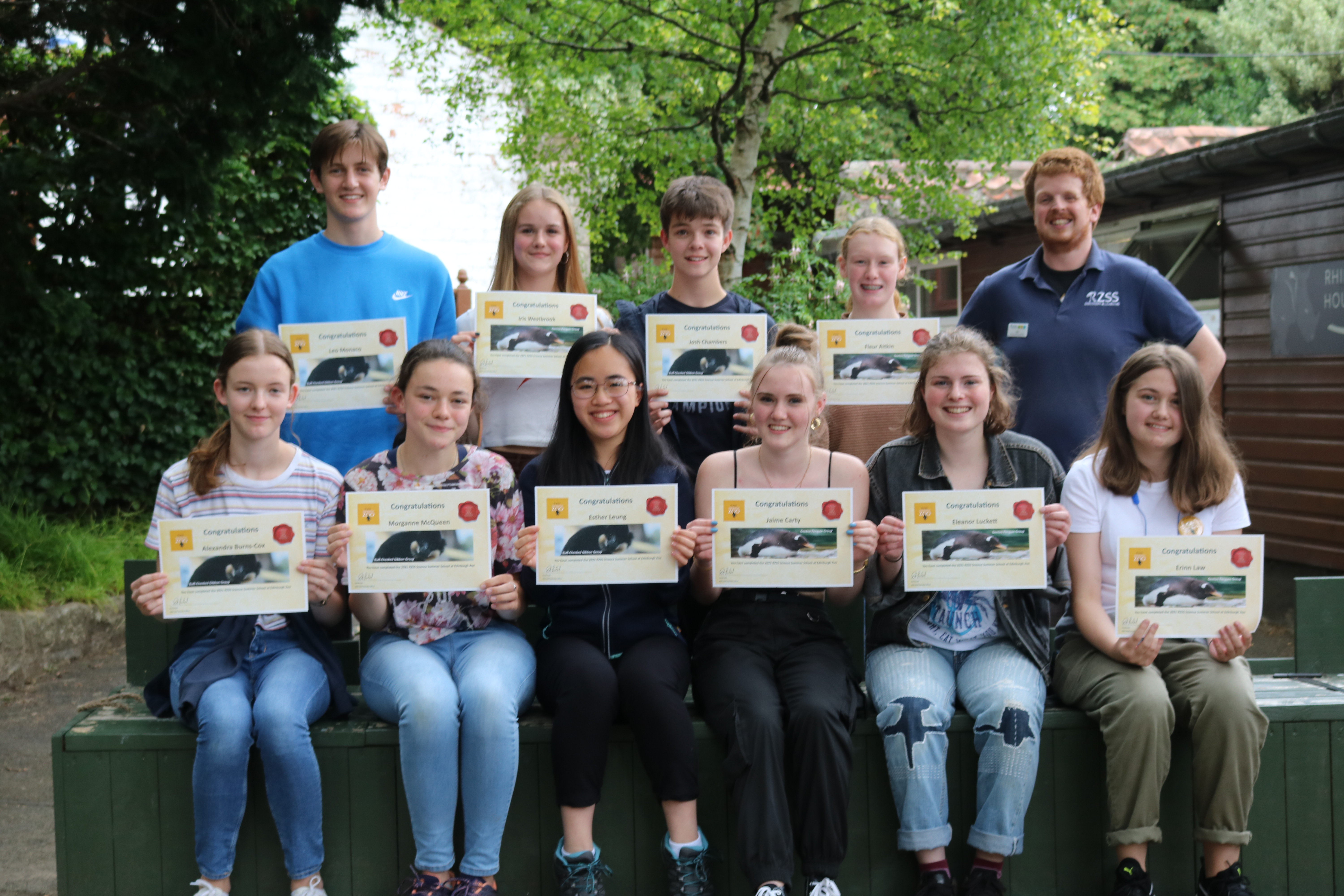 Science summer school students holding certificates